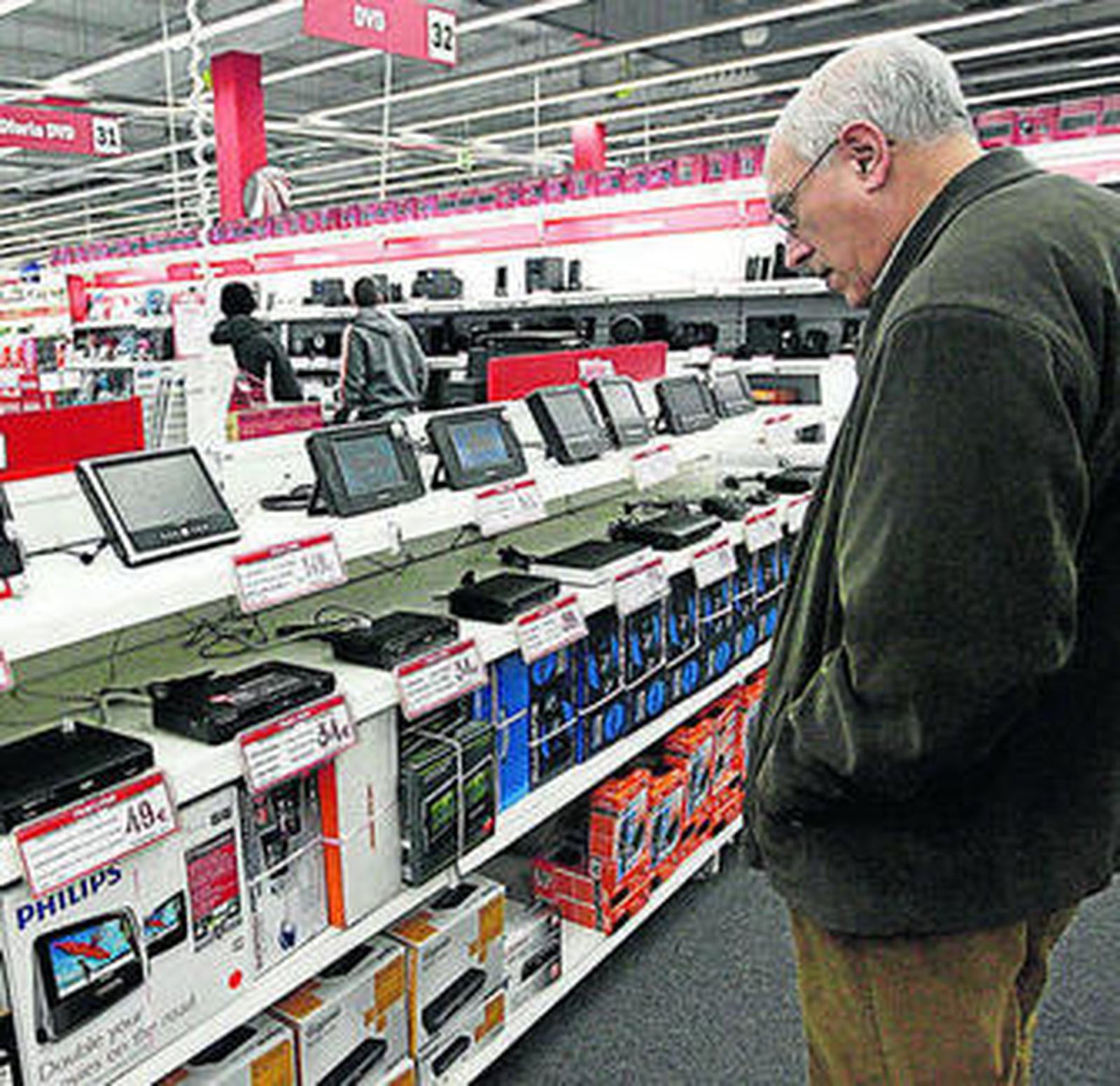 Un hombre mira adaptadores para la TDT.
