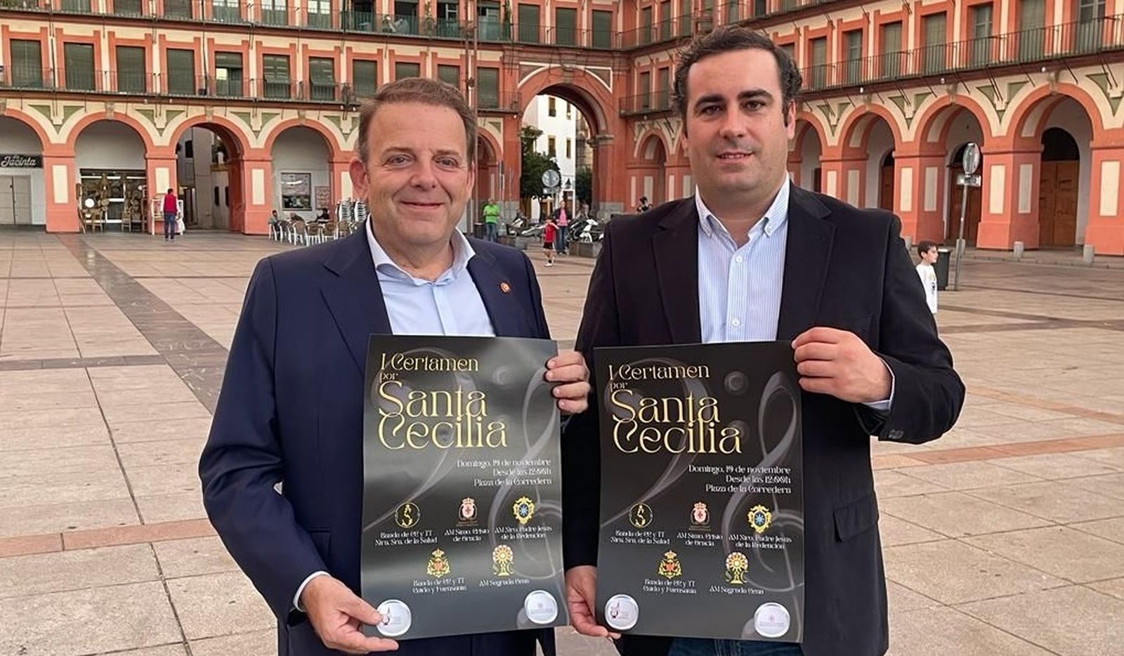 Julián Urbano y Sebastián Giraldo posan en La Corredera con el cartel del certamen.