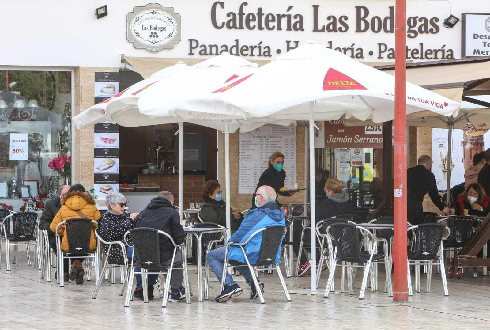 Clientes en la terraza de una cafetería un día antes del cierre de la actividad no esencial