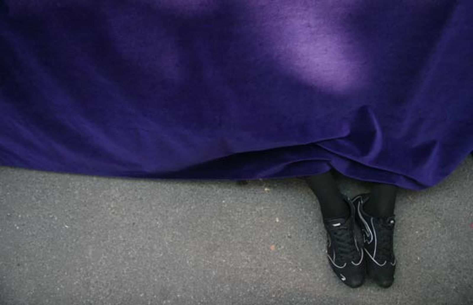 Un costalero descansa sentado bajo el paso de Misterio.

Foto: Belén  Vargas