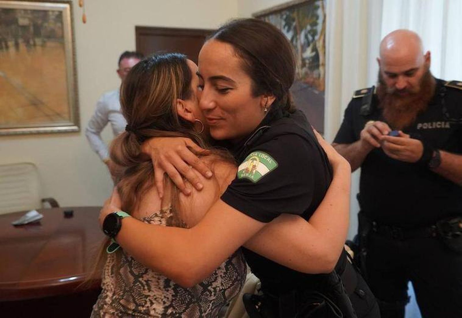 La  agente se abraza con un familiar del vecino evacuado