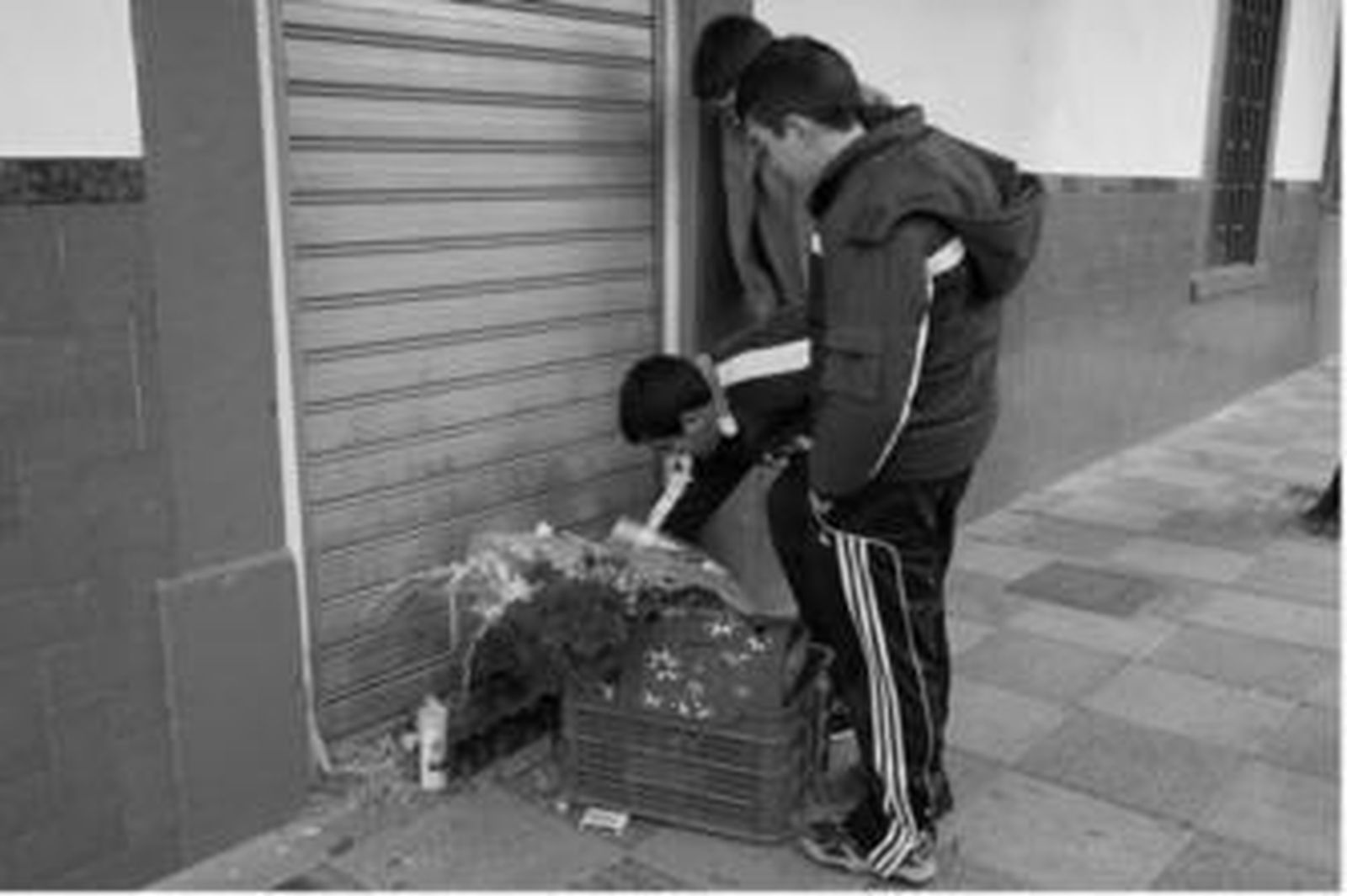 Varios niños ponen flores en el lugar del asesinato.