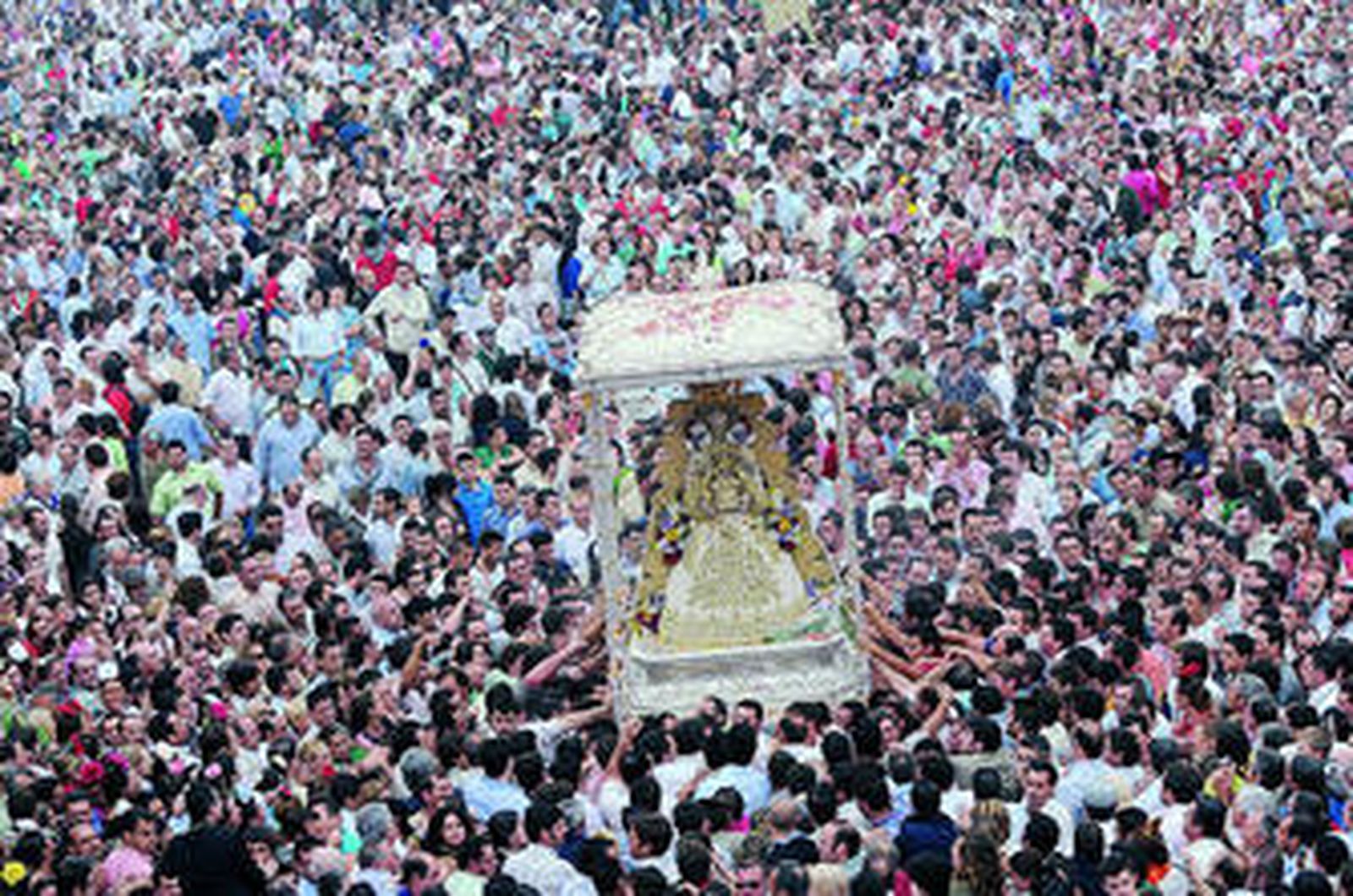 La Virgen del Rocío, rodeada de personas, durante la procesión de alabanza.