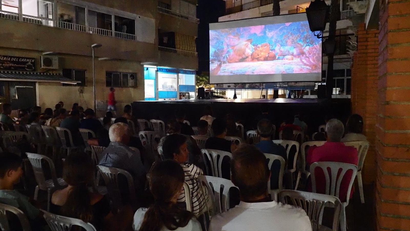 Vecinos viendo una película al aire libre