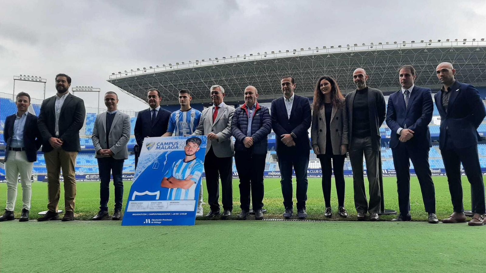 Los asistentes posaron junto al cartel.
