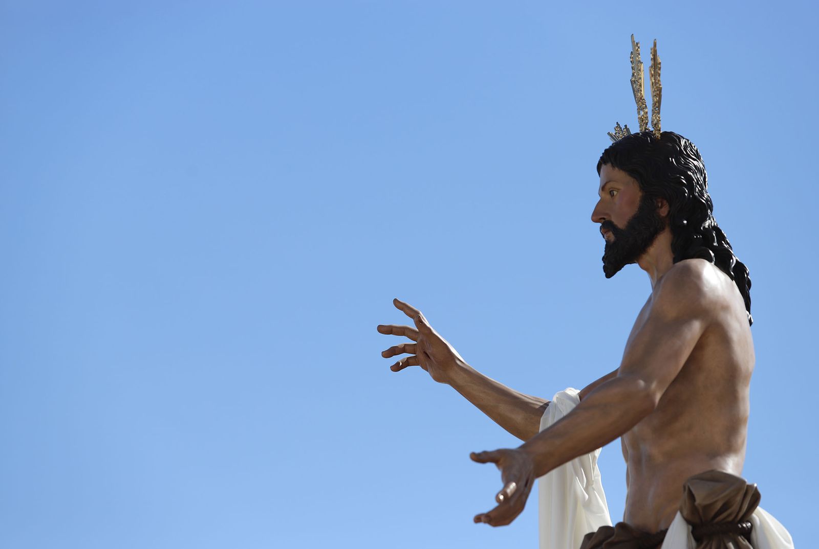 El Resucitado procesiona por el barrio de la Hispanidad de Huelva