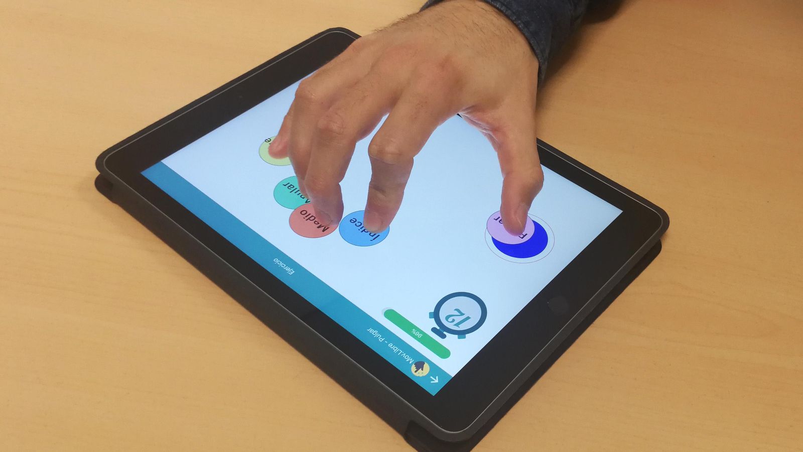 Un paciente utiliza la tablet para realizar un ejercicio de rehabilitación de Rehab, basado en toques y recorridos por la pantalla.