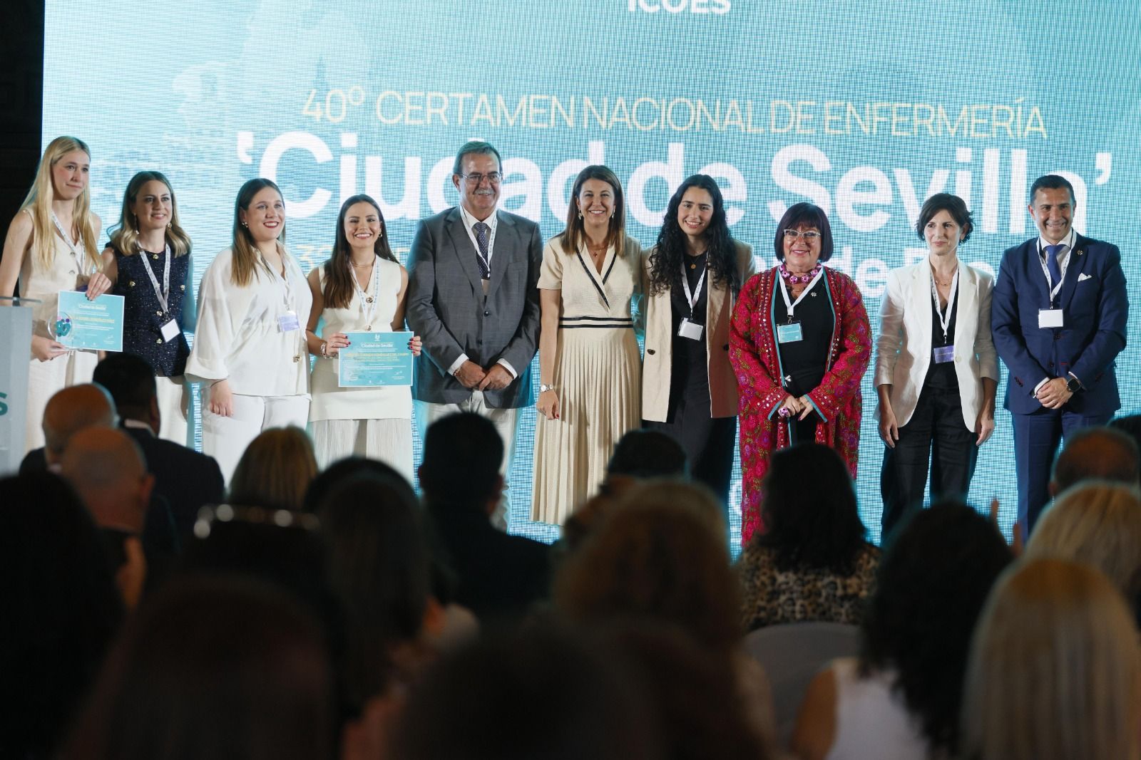 Foto de familia de los premiados con las autoridades y el presidente del Colegio de Enfermería de Sevilla, Víctor Bohórquez.