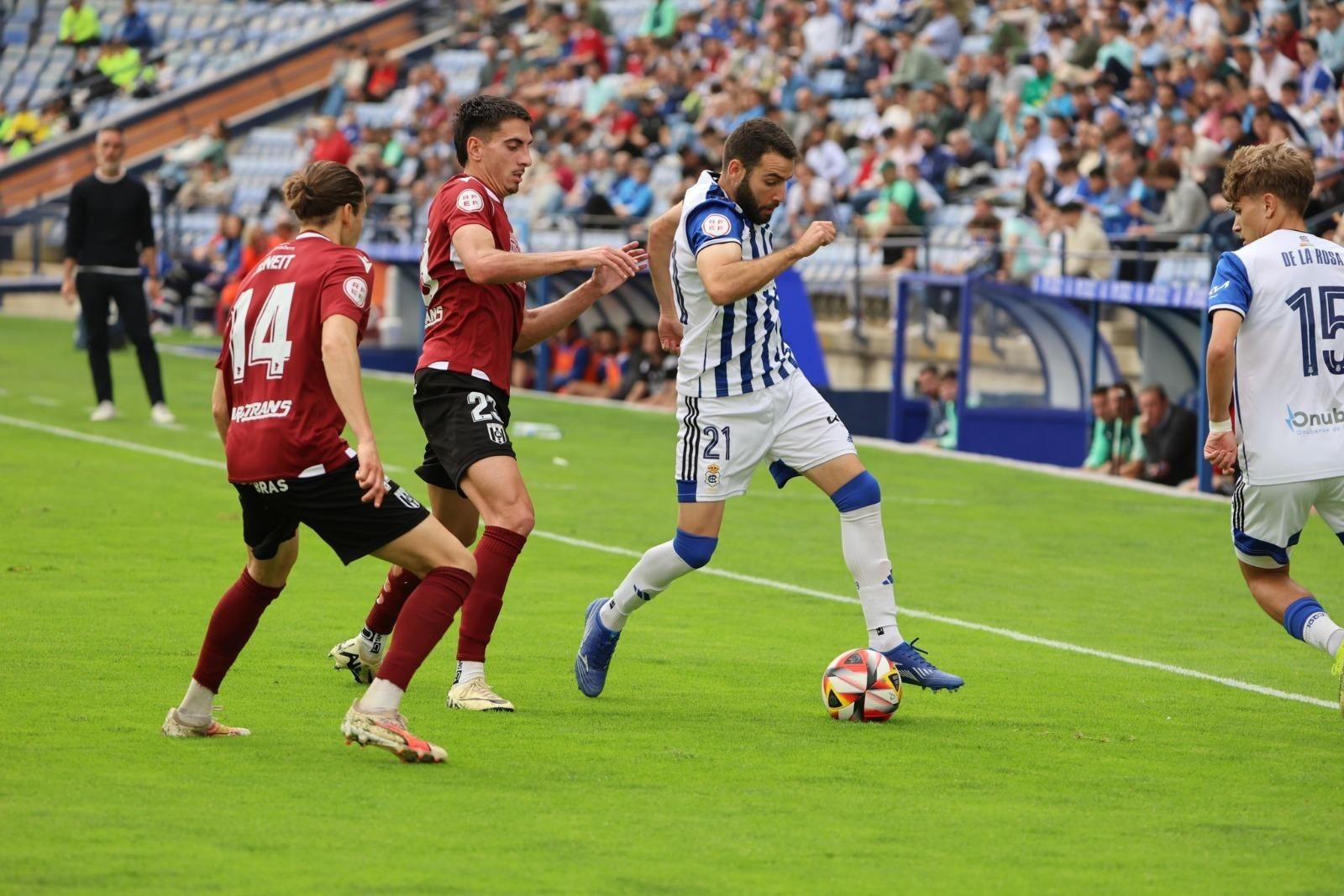 Antoñito controla el balón bajo la atenta mirada de De la Rosa.