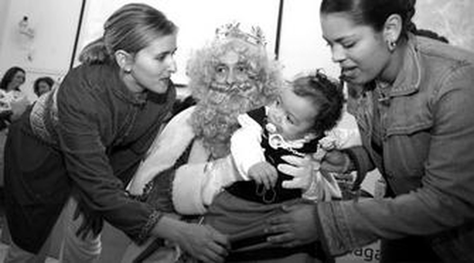 El Rey Gaspar atiende a una de las niñas que ayer se vistió de pastora para la fiesta navideña.