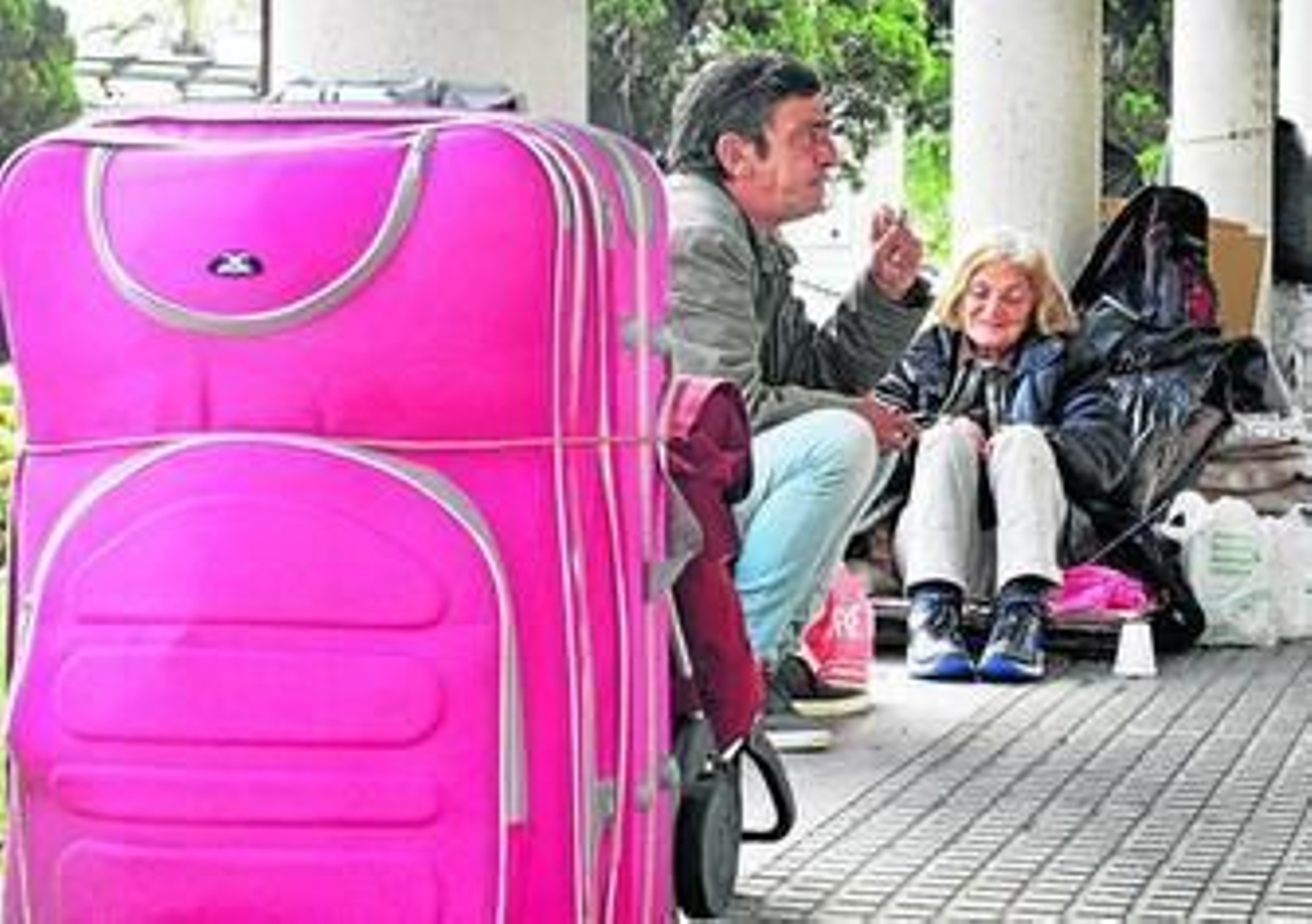 Dos personas buscan refugio en la plaza de las Tortugas.