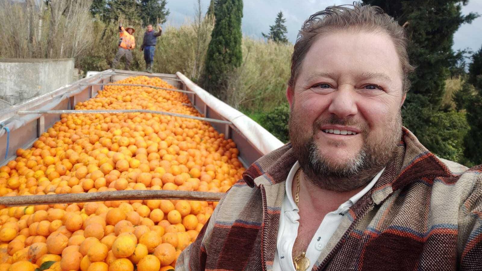 Cristóbal Jaime, con su camión cargado de naranjas.