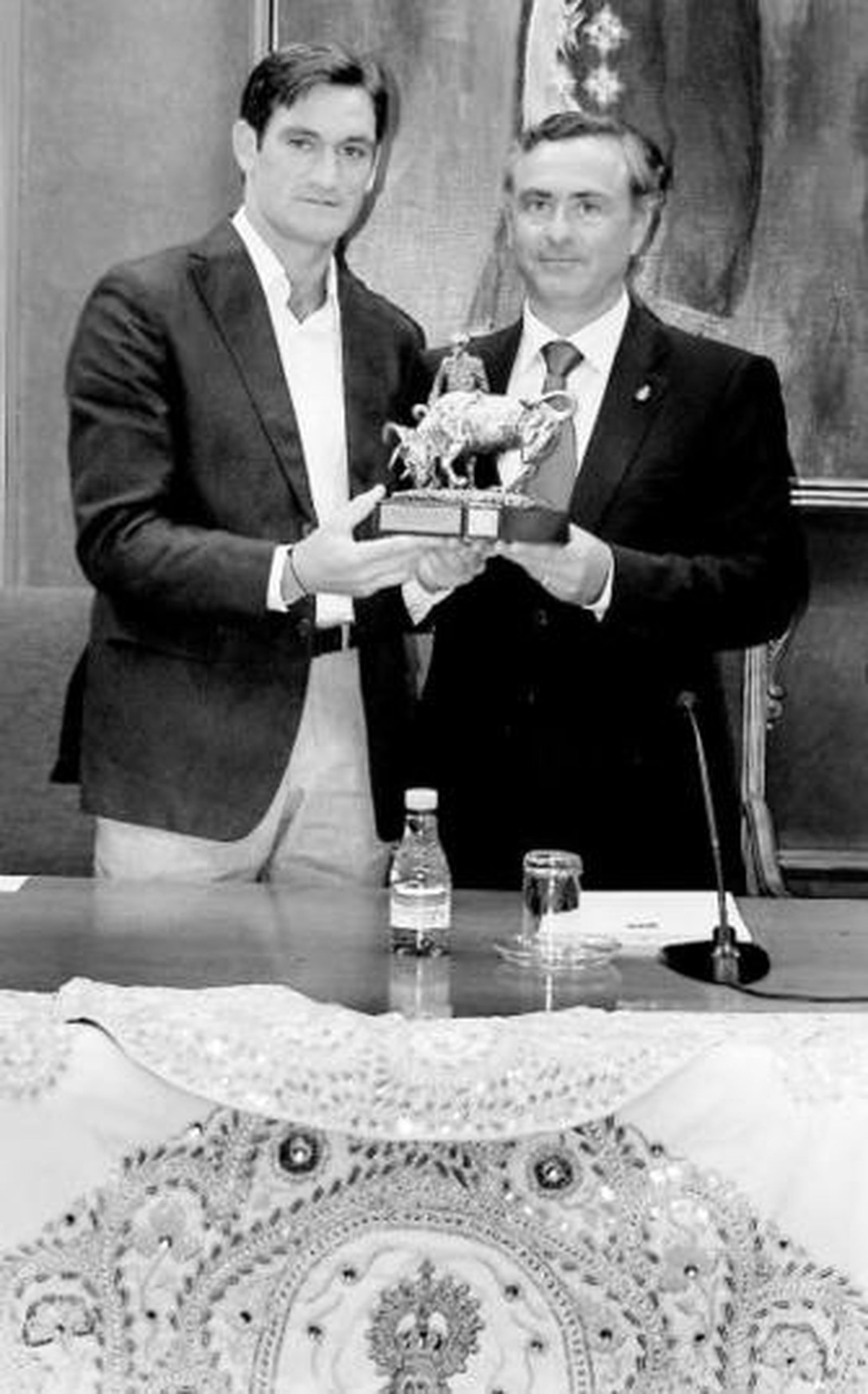 El presidente de la diputación hace entrega del trofeo al diestro.
