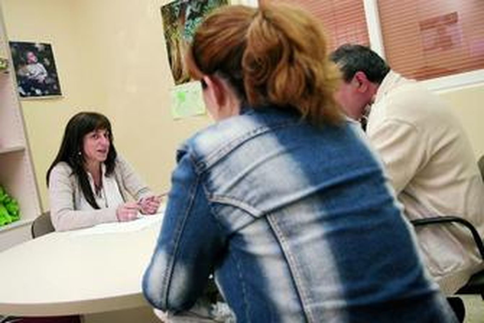 Olga, una de las psicólogas del Cemaif, charla con Ana y Ángel en las instalaciones del centro.
