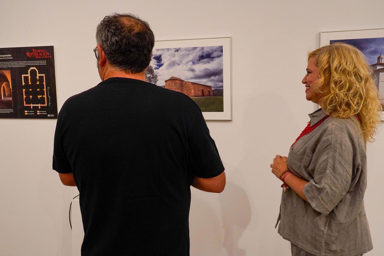 Imágenes de la inauguración de la exposición 'Ermitas de repoblación en la Sierra de Huelva' por La diputada de Cultura, Gracia Baquero, y el autor de la exposición, Jorge Garrido.