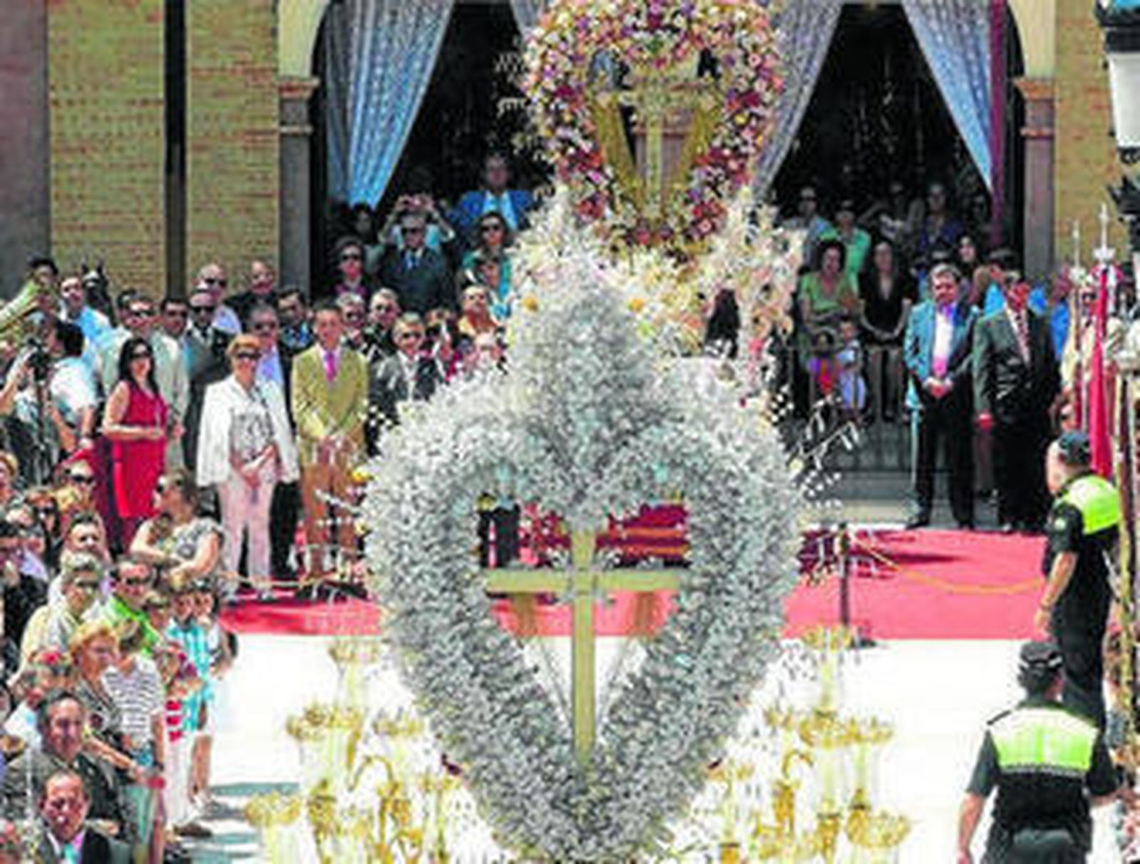 1. Dos de los Santos Maderos adornados con flores. 2. Cruz en el interior de una capilla de la localidad bonariega. 3. Una mujer trabaja en el exorno de una de las Cruces. 4. 5. y 6. Desfile de las Cruces de Mayo de Bonares, una festividad que está incluida el catálogo general del patrimonio artístico andaluz.