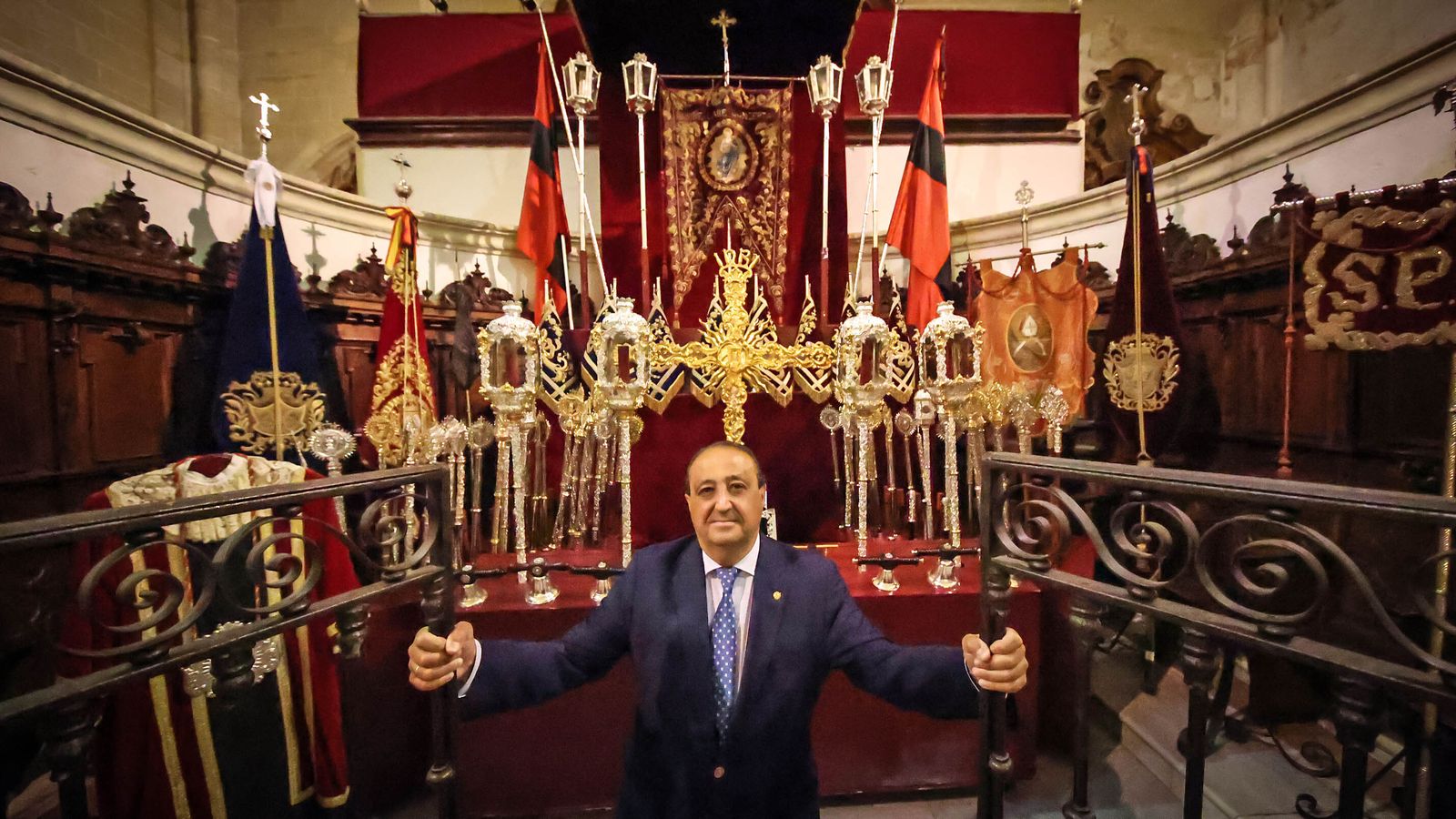 El pregonero abre la reja del coro de la iglesia de San Mateo ante el impresionante altar de insignias.