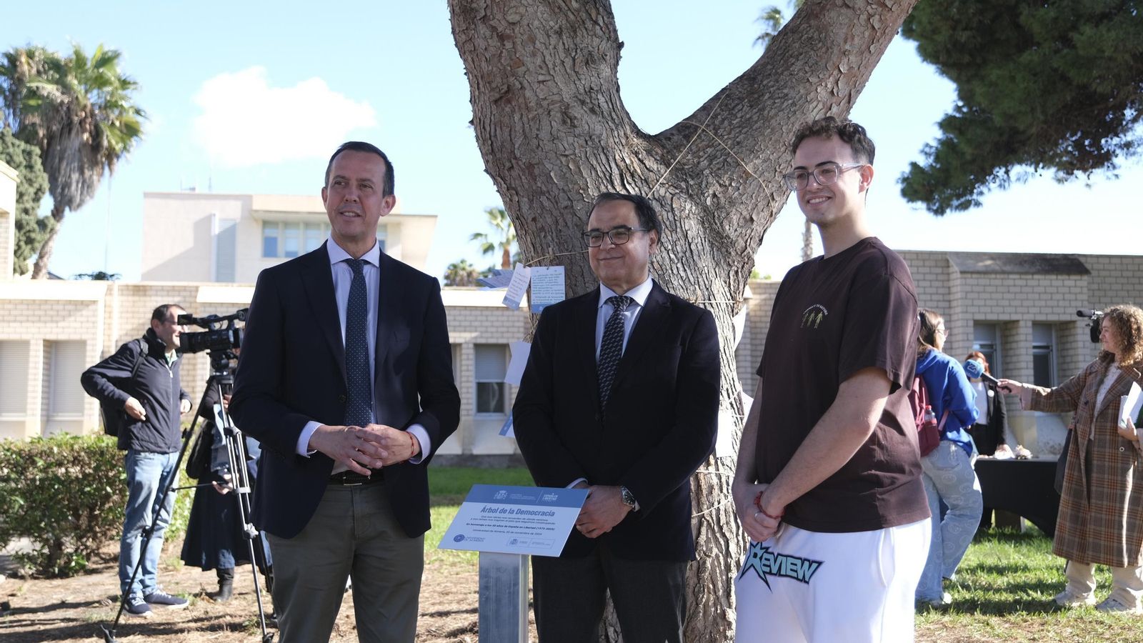 El subdelegado del Gobierno, el rector de la UAL y un estudiante, junto al árbol.
