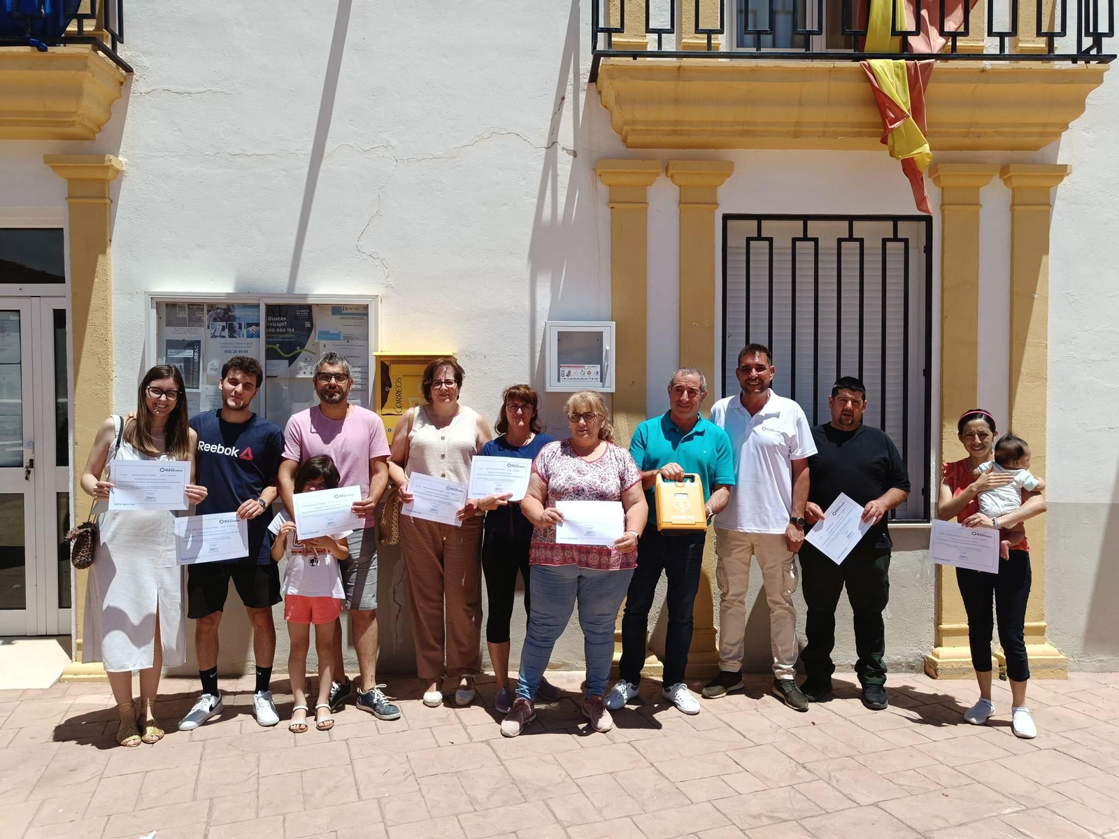 Vecinos del municipio de Alcóntar (Almería) formados para saber usar el DESA que han instalado en su municipio, junto la teniente alcalde y el profesional sanitario que ha impartido la formación