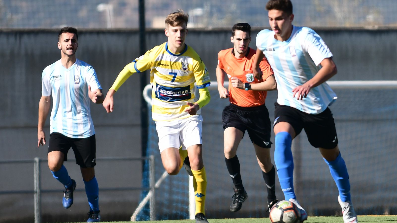 Un jugador del Don Bosco conduce el balón ante la presión de un coriano.