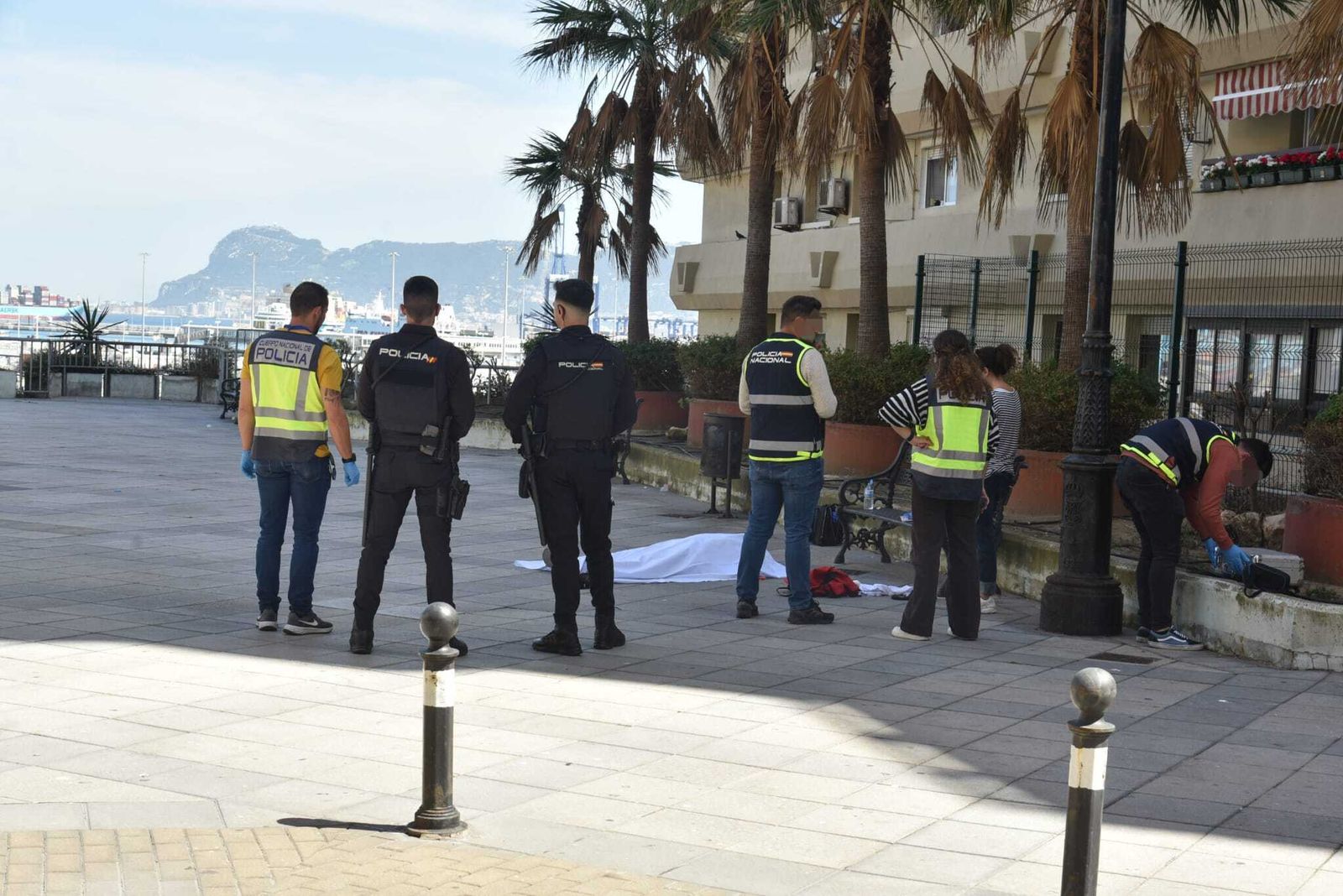 La víctima, cubierta con una sábana, en la plaza Virgen de las Lágrimas.
