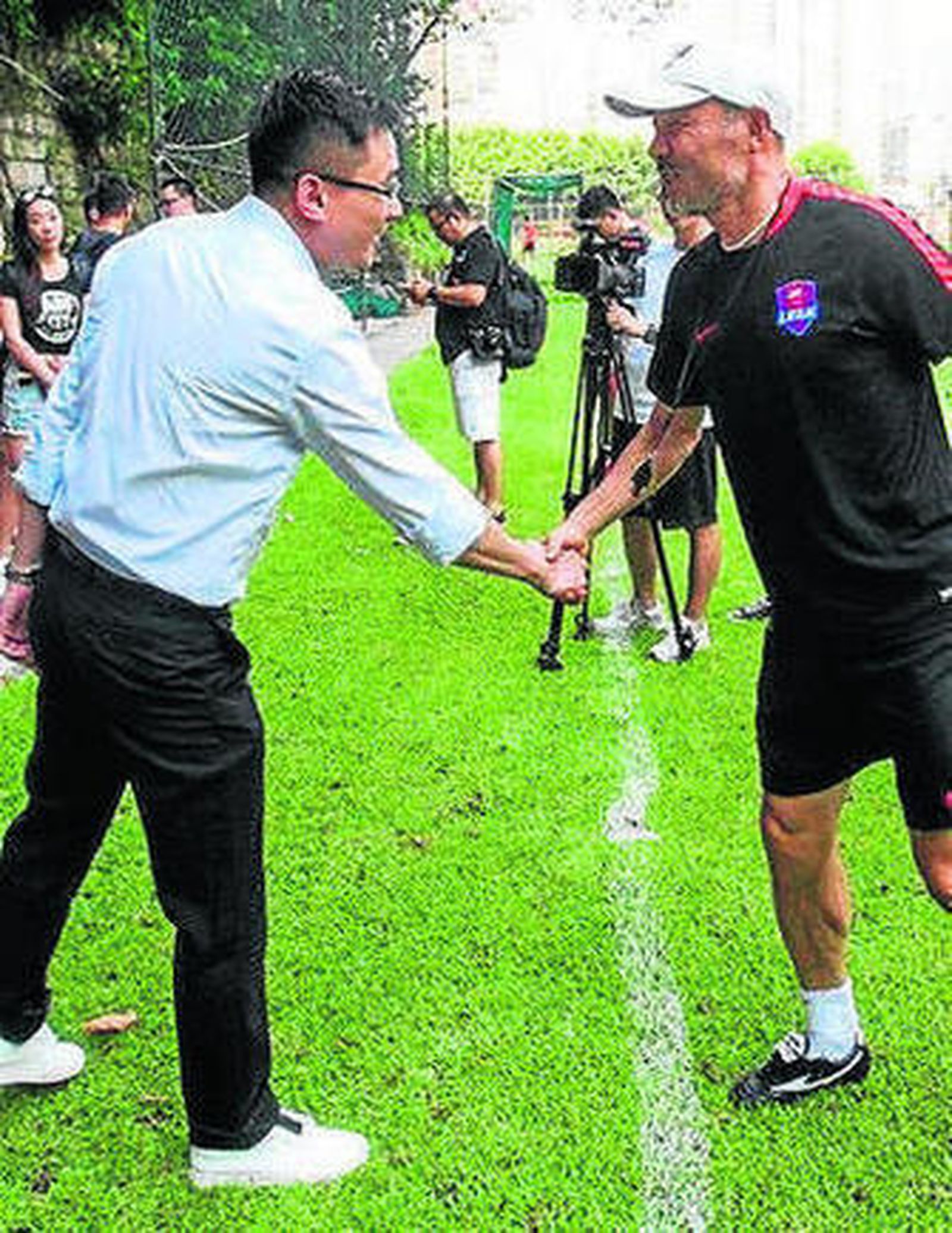 Jiang saluda al técnico del equipo.
