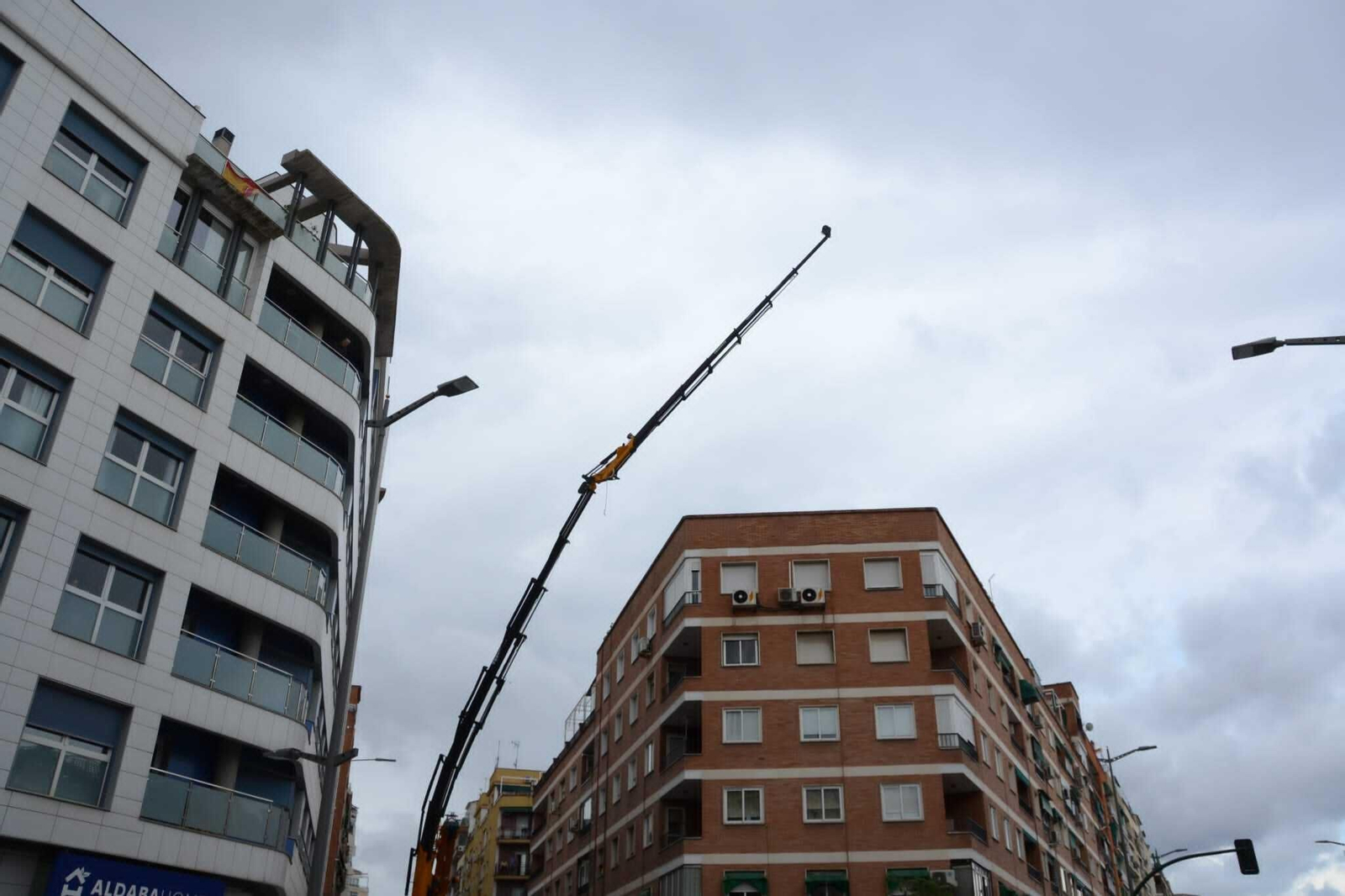 Una mujer resulta ilesa tras caer sobre su vehículo la carga de un camión grúa, en imágenes