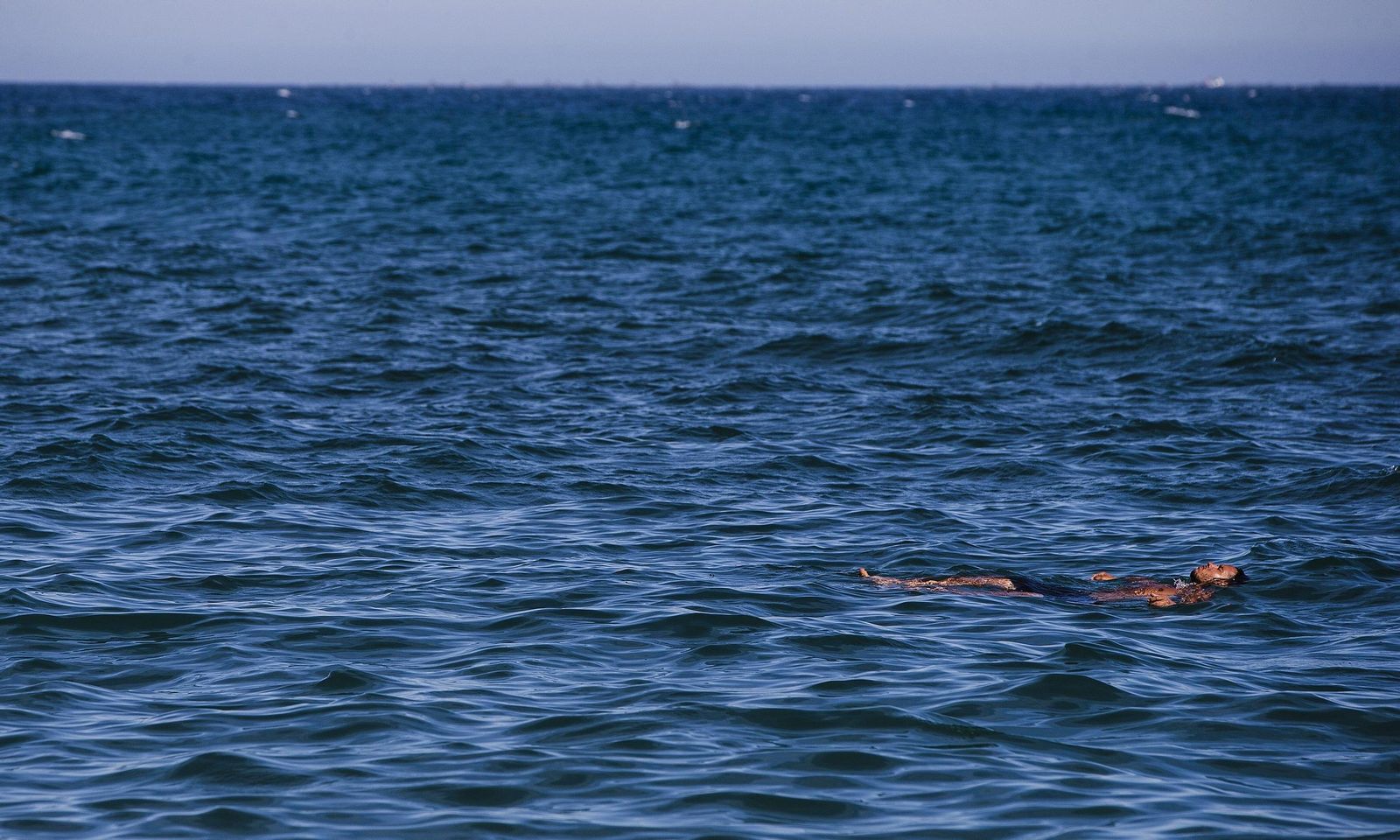 Un hombre se da un baño en el mar