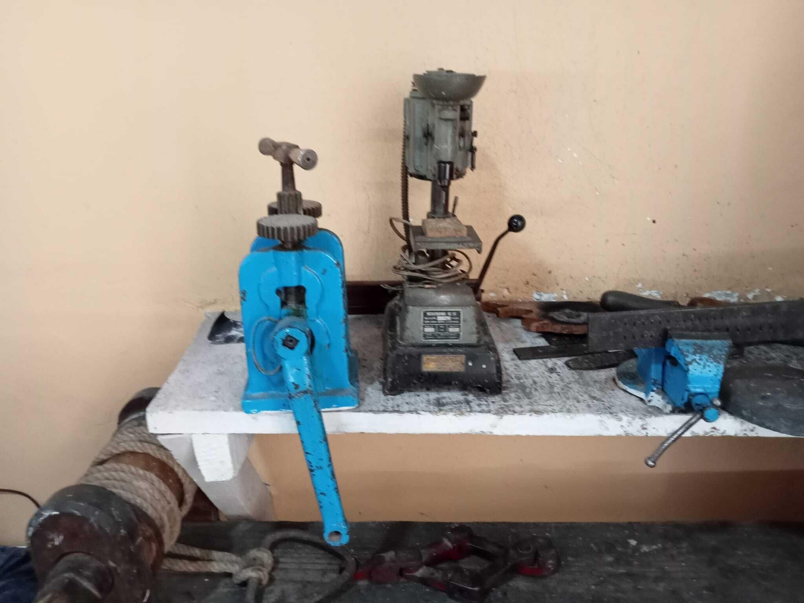 A la izquierda un cilindro que se utiliza para dar formar a los metales, a la derecha, taladro A la izquierda un cilindro que se utiliza para dar formar a los metales