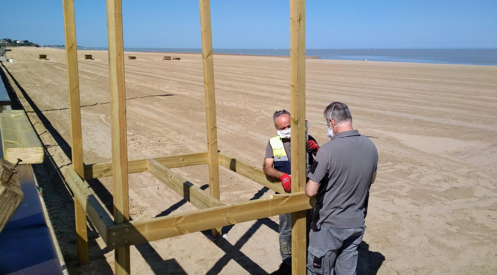 Operarios del Ayuntamiento trabajando este lunes por la mañana en las playas de Sanlúcar.