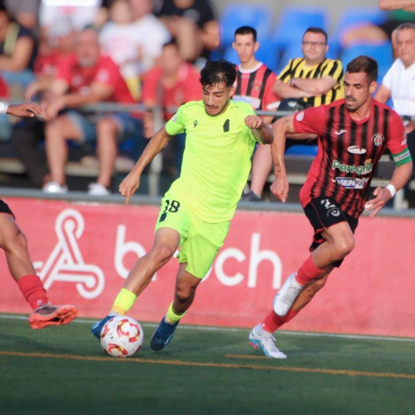 Un jugador del filial albinegro intenta irse del capitán rojinegro Gabi Ramos en una acción del encuentro.