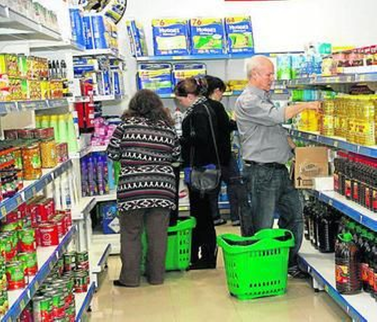 Un grupo de onubenses realiza su compra en el Economato de Resurgir, para personas con serias dificultades.