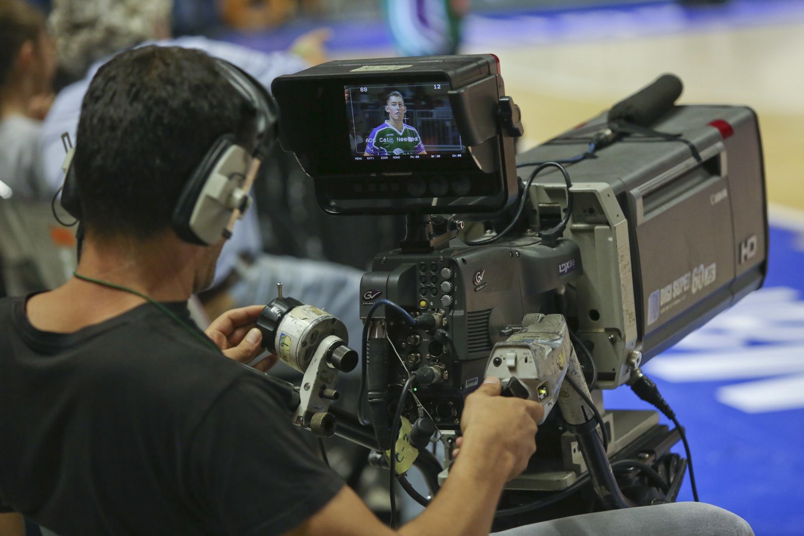 Un operador de cámara durante la grabación de un evento deportivo.