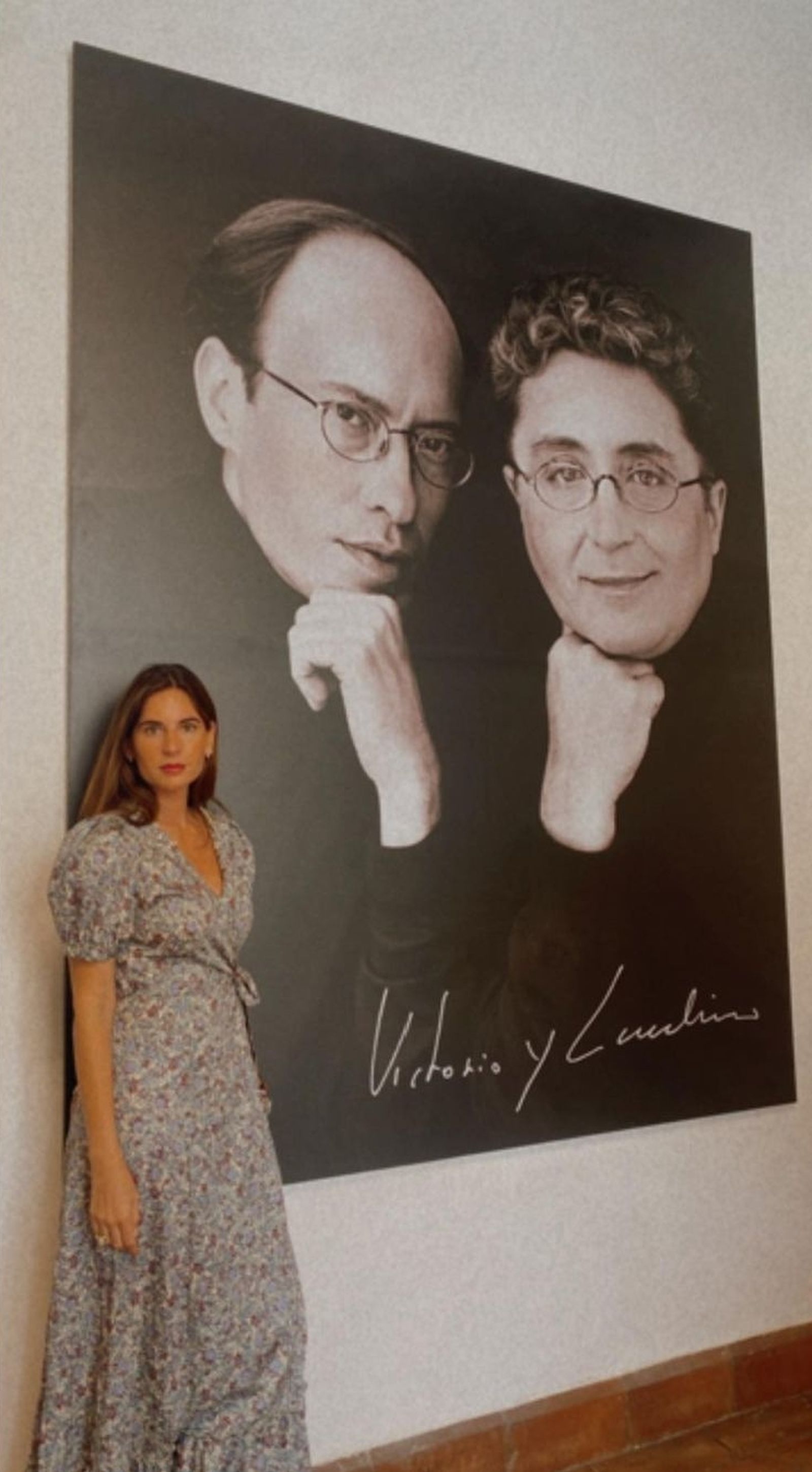 La diseñadora Lourdes Montes posando junto al retrato de sus admirados colegas