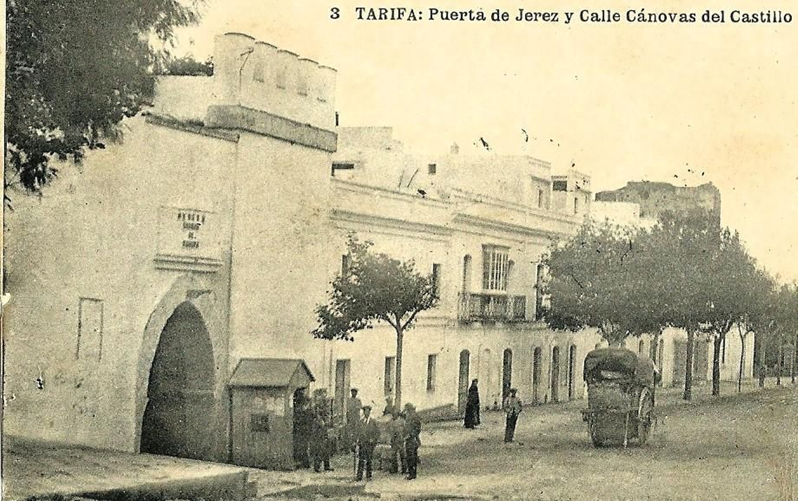 Imagen de la Puerta de Jerez y su entorno a comienzos del siglo XX. Se observa la casilla de consumos y la antigua lápida con la leyenda “M N M L Y H ciudad de Tarifa”. Imagen de la Puerta de Jerez y su entorno a comienzos del siglo XX. Se observa la casilla de consumos y la antigua lápida con la leyenda “M N M L Y H ciudad de Tarifa”.
