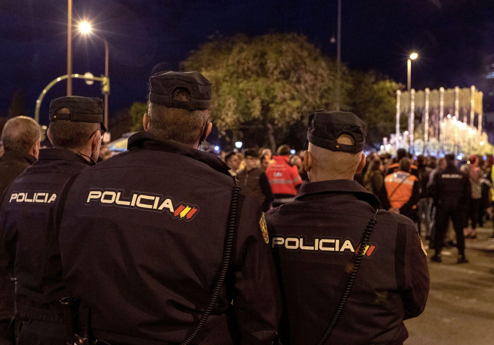 Agentes de la Policía Nacional vigilan el paso de la Hermandad de la Esperanza de Triana la pasada Madrugada.