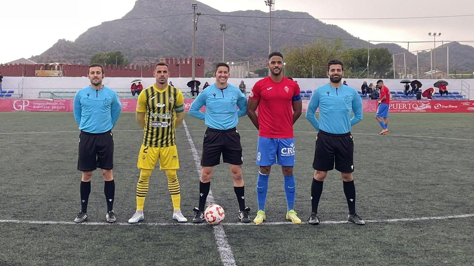 Los capitanes del Santomera y del Atlético Pulpileño posan con el trío arbitral antes del comienzo del partido.