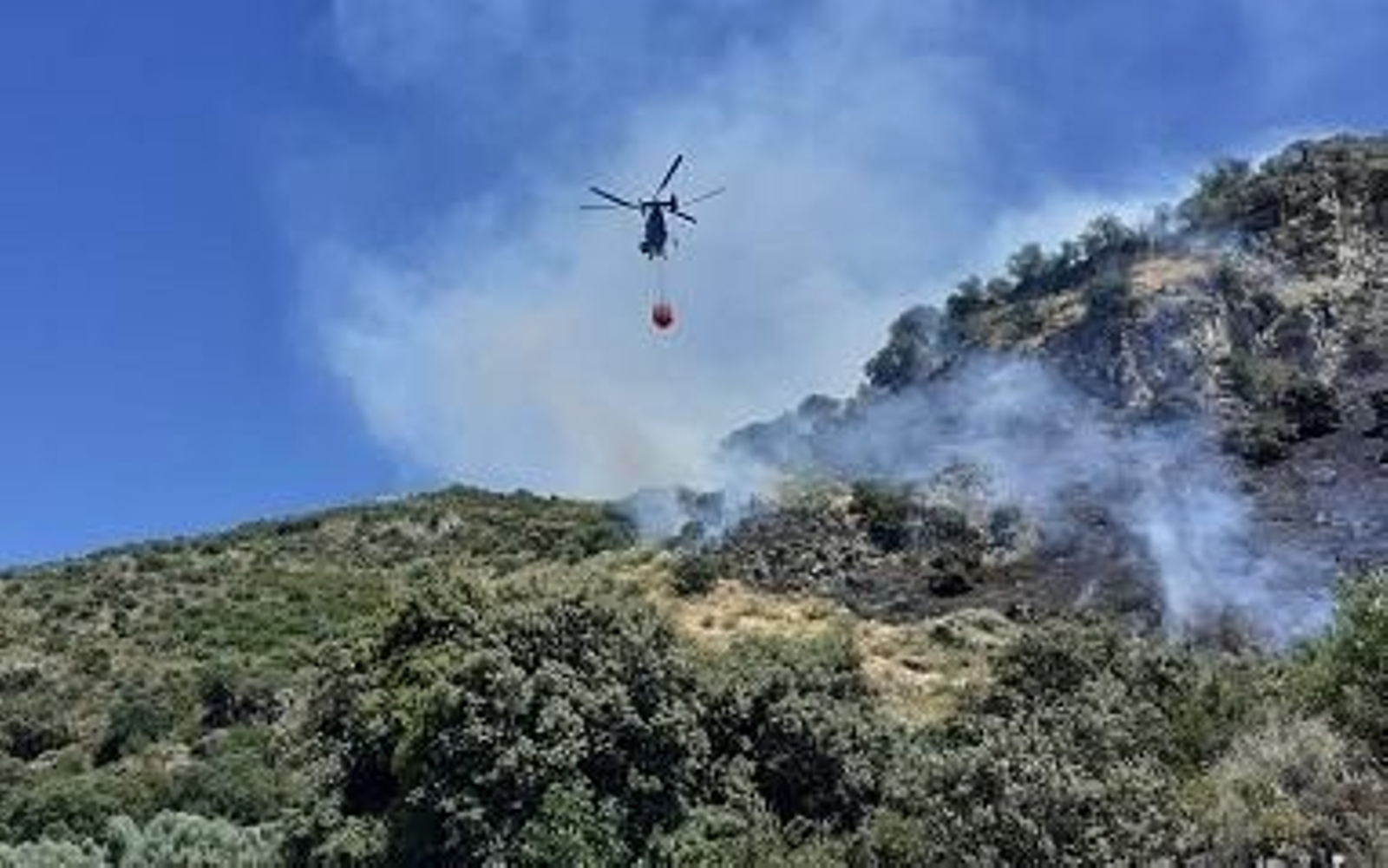 El helicóptero realiza las labores de extinción.