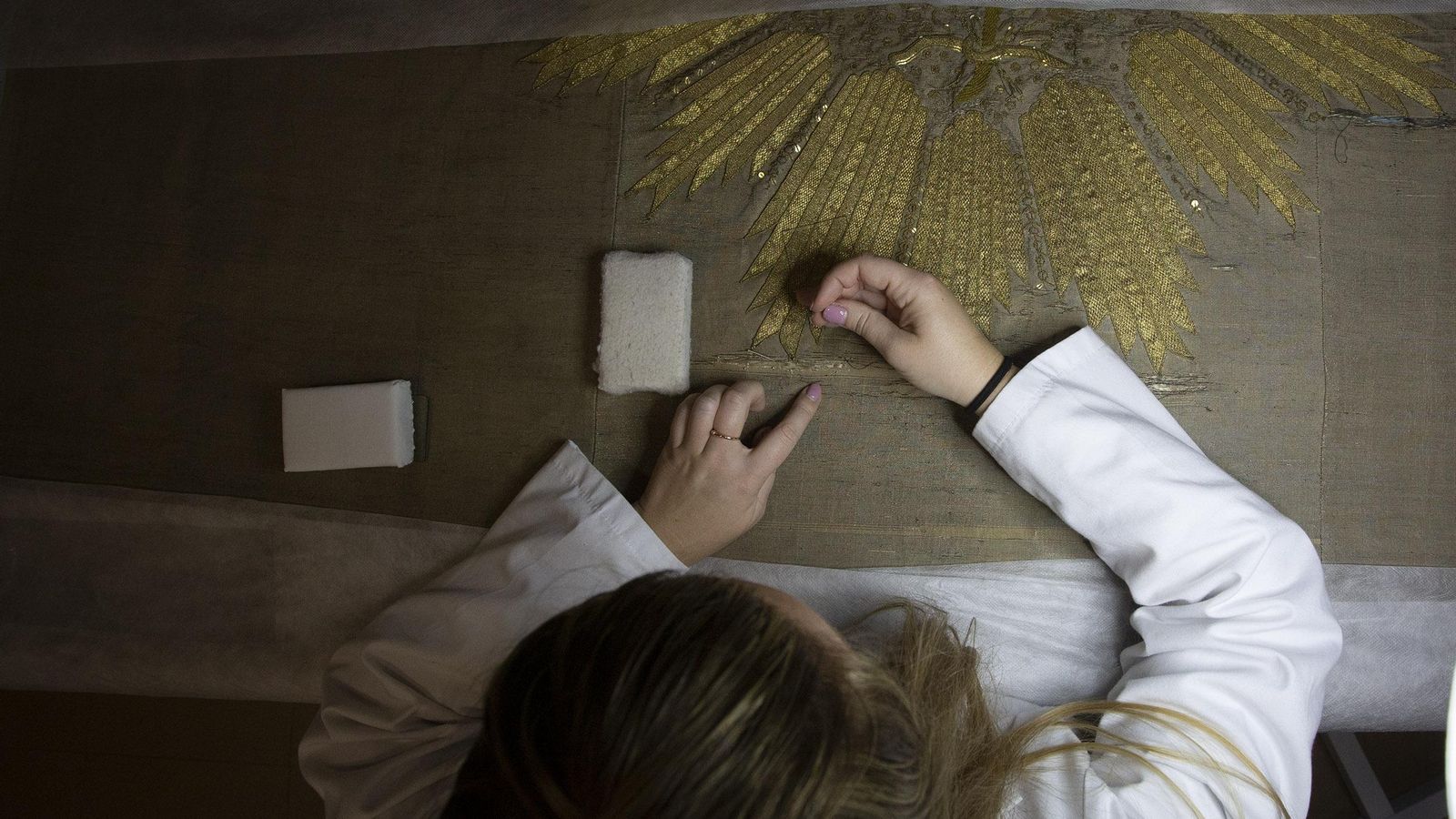 Maite Romo repara el tejido base de un palio de respeto.