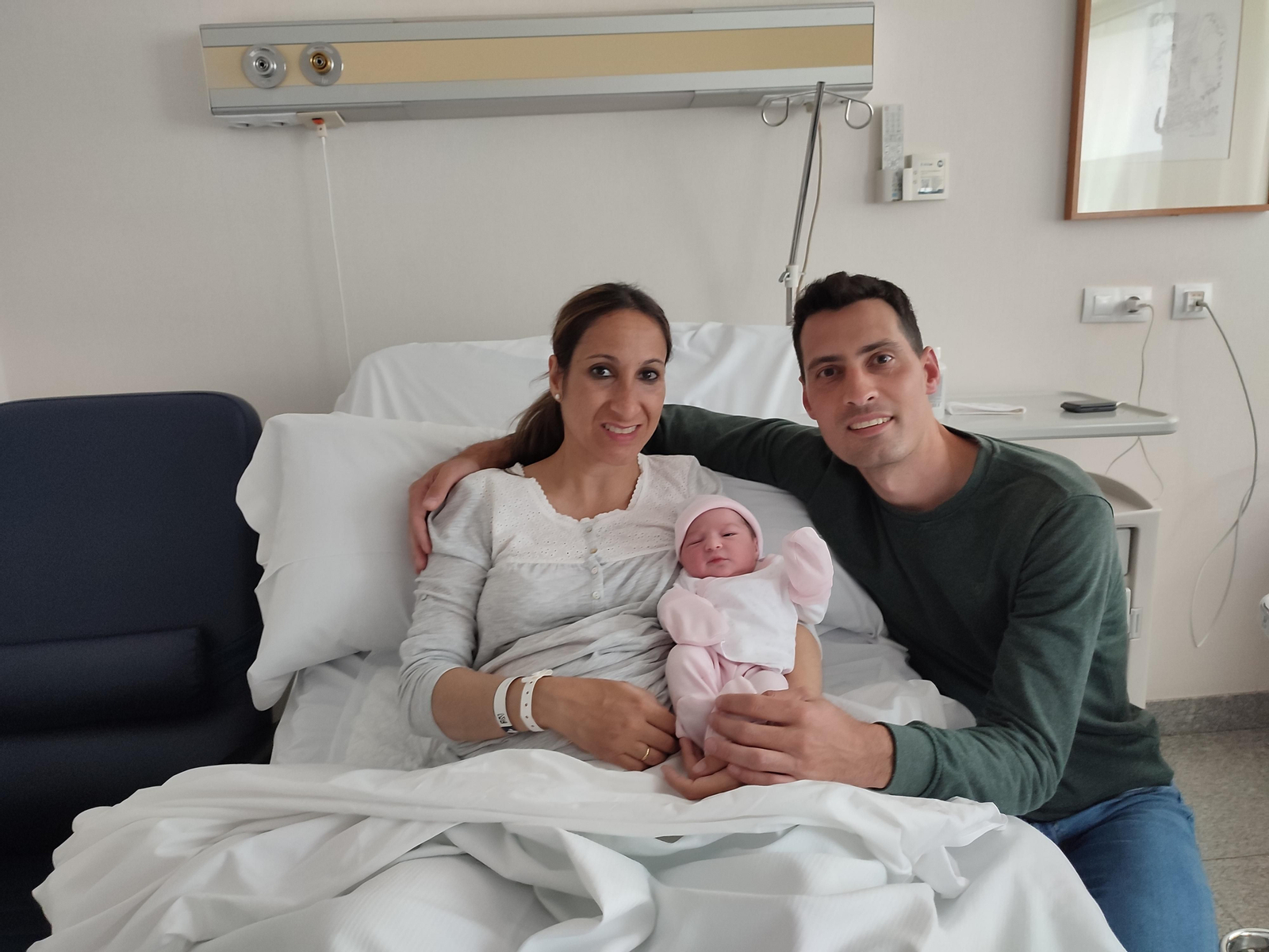 La pequeña Julia junto a sus padres, Mari Carmen y Antonio, en la habitación del hospital.