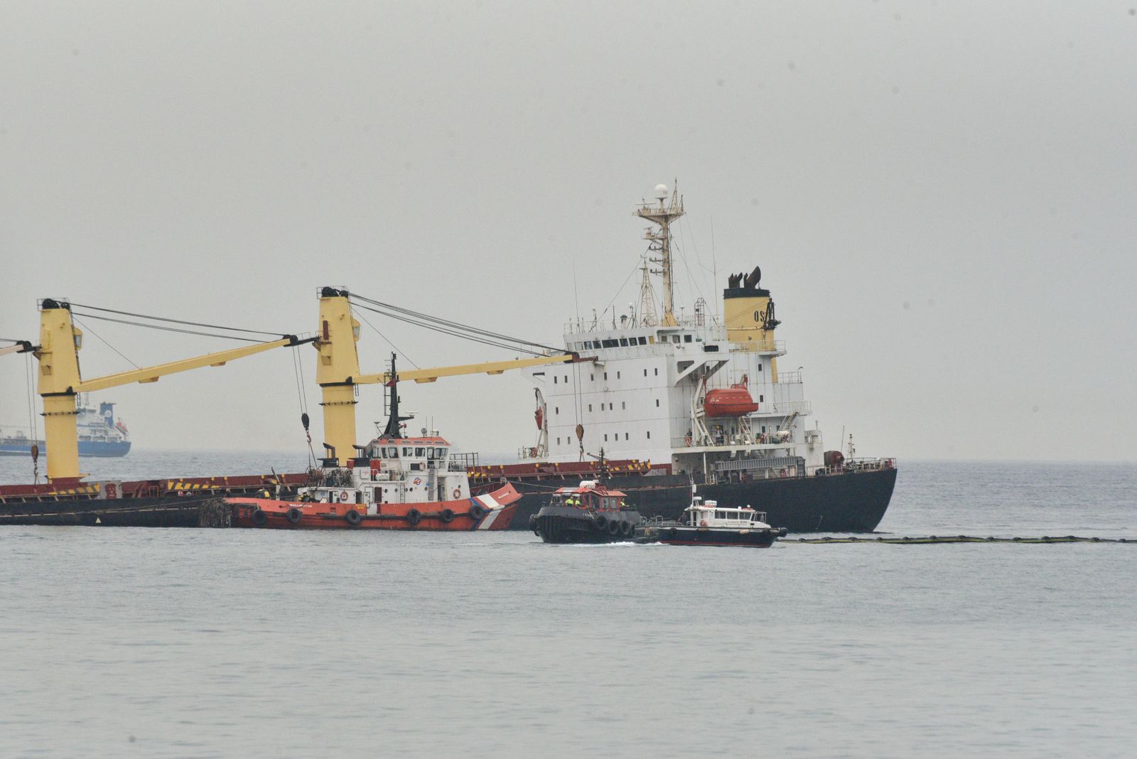 El granelero OS 35 encallado, junto a distintas embarcaciones que actúan en la zona.