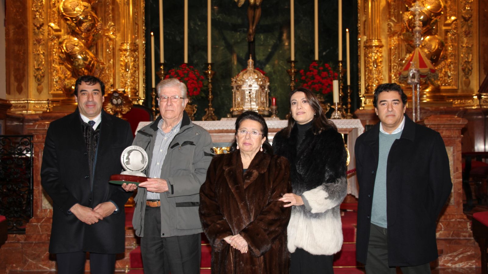 Ángel Vela muestra el galardón junto a los familiares de Pepe Peregil.