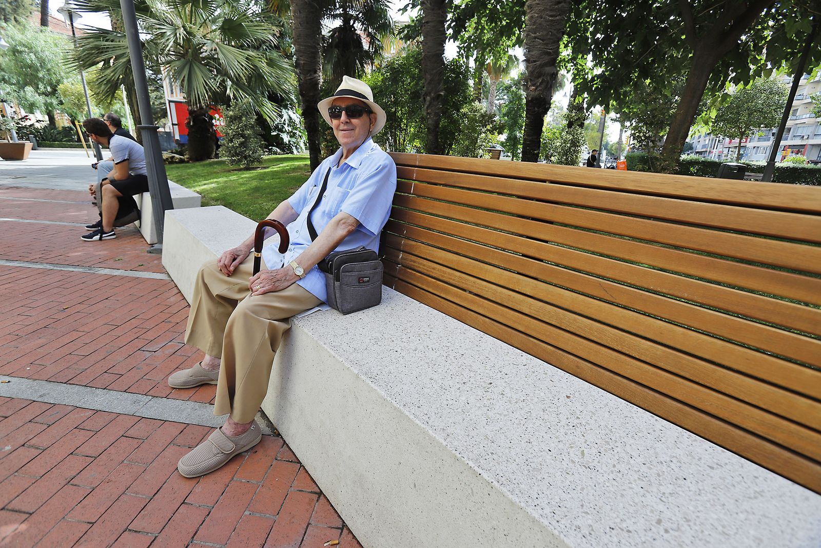 Un peatón descansa en los nuevos bancos de la Plaza del Punto.