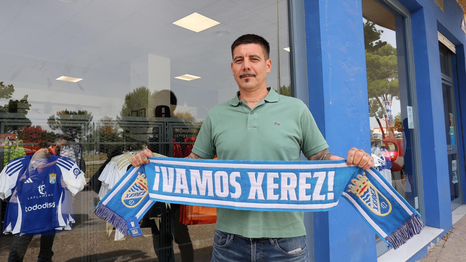 Miguel Ángel Gutiérrez ‘Gallo’ posa con una bufanda del Xerez CD en la puerta de la sede del club azulino.