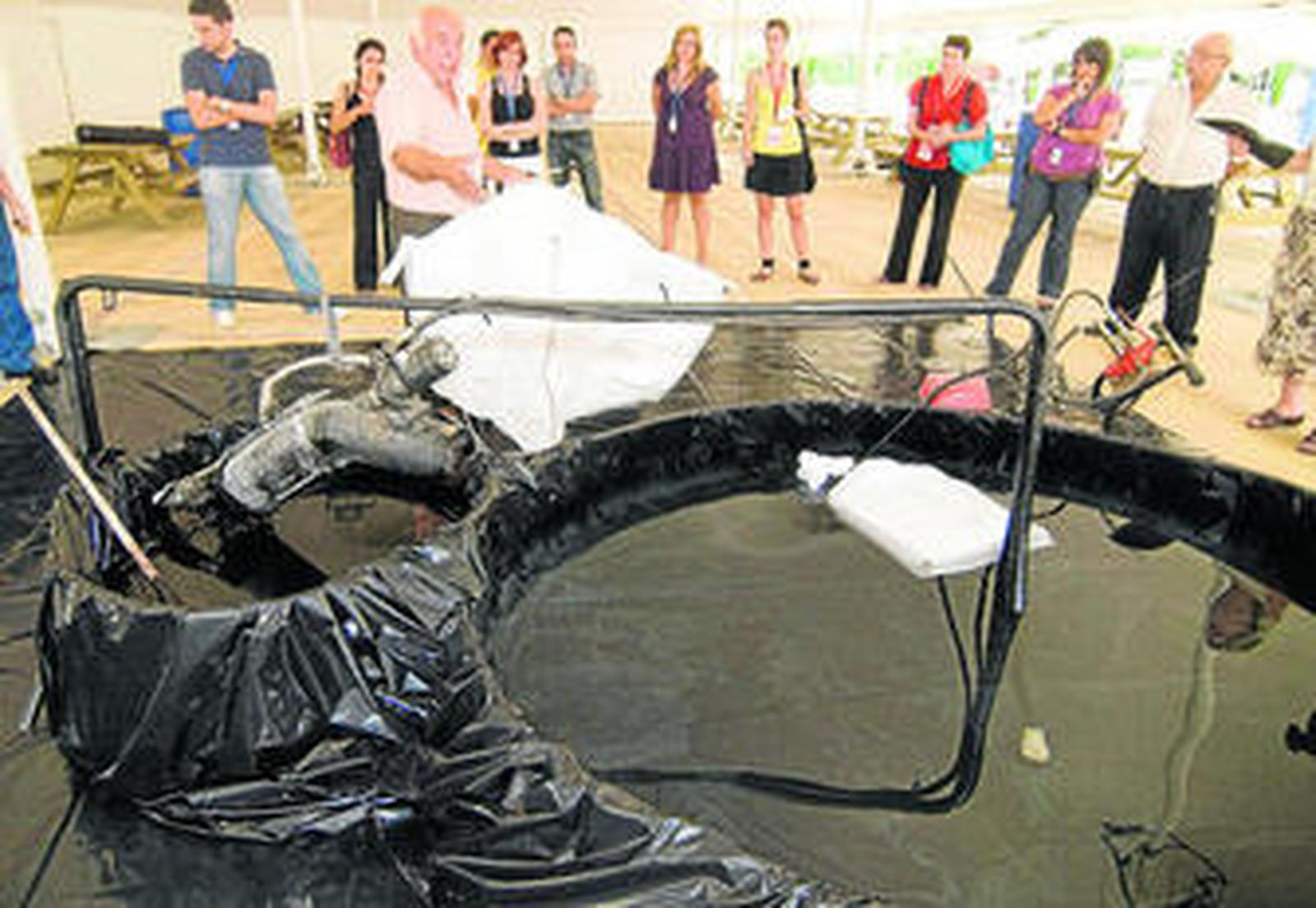 El inventor del sistema explicando el mecanismo de la máquina recoge-chapapote.