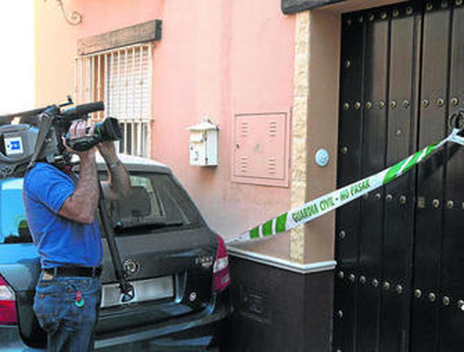 Un cámara de televisión graba la puerta del domicilio donde se produjo el asesinato.
