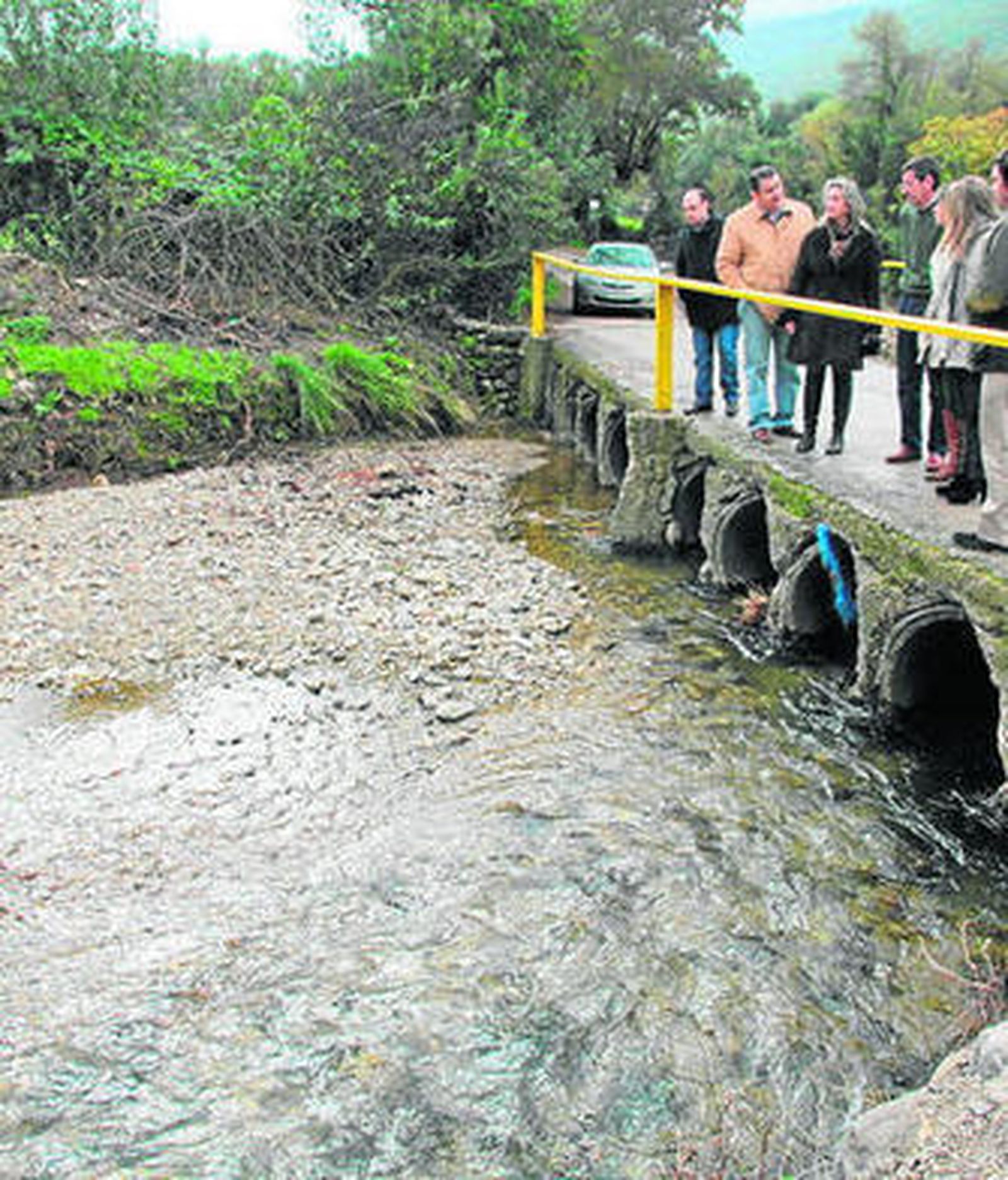 Los representantes del PP, revisando un puente de la zona.