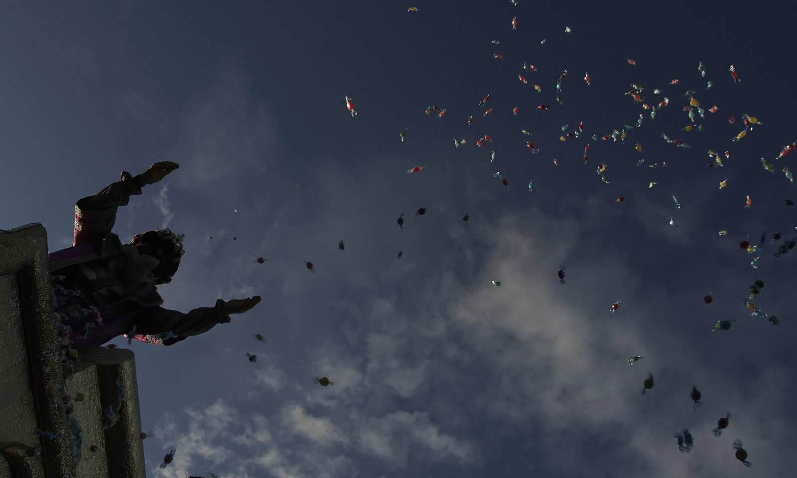 Un rey mago lanza caramelos en la cabalgata de reyes de Sevilla.