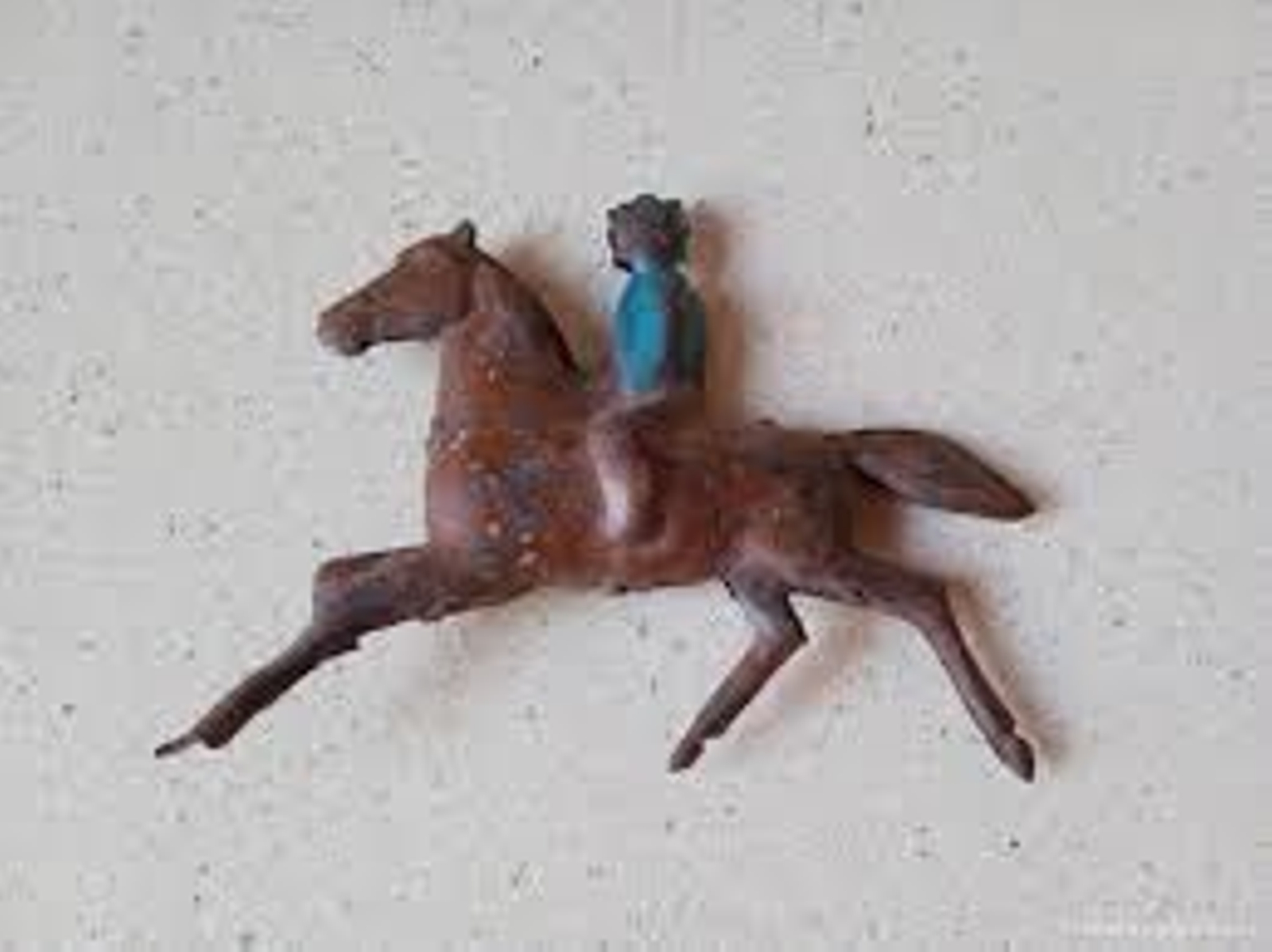 Juguete de hojalata caballo de carreras