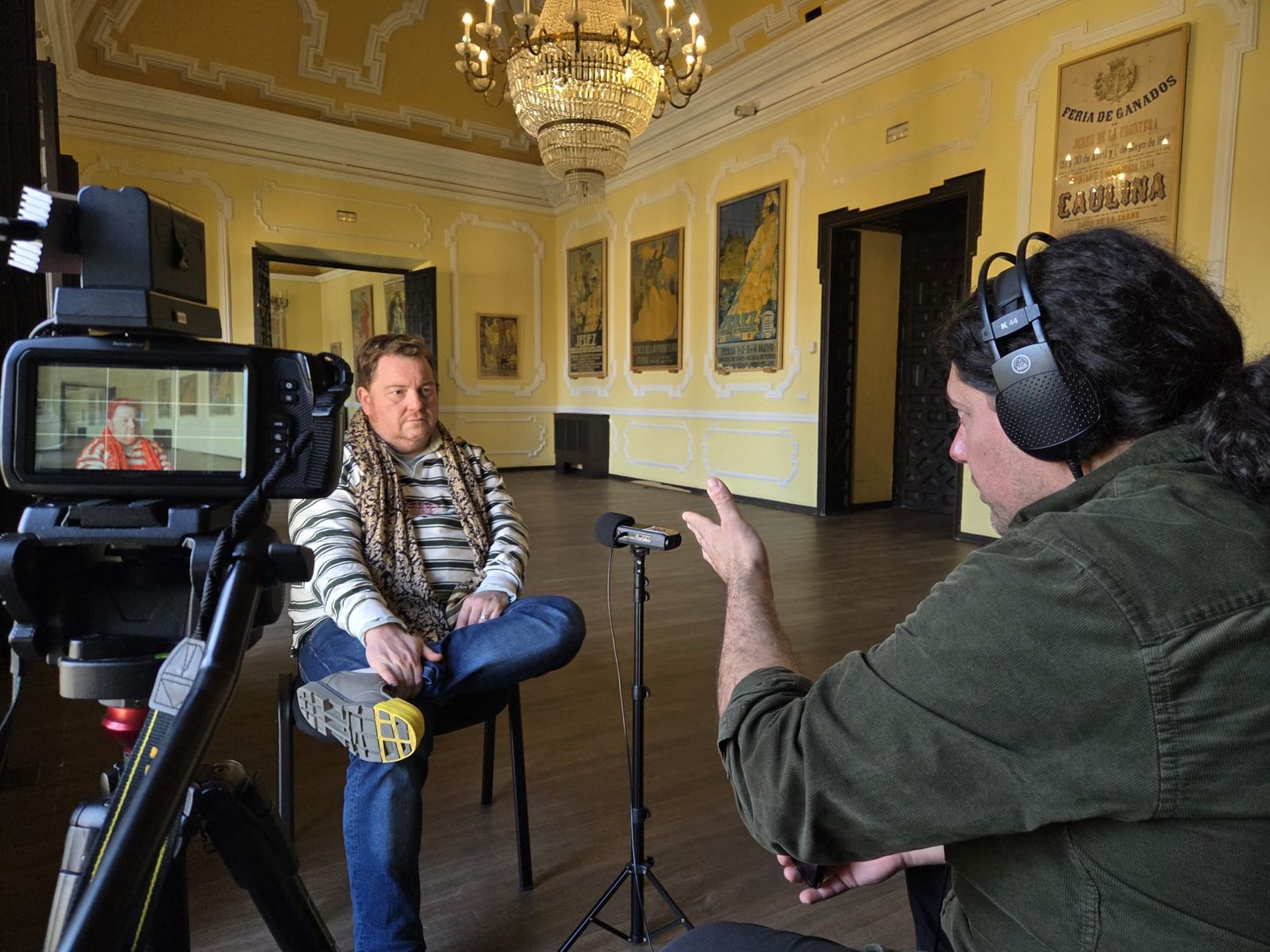 El nieto de Carlos Gallegos García-Pelayo, durante la grabación en el Alcázar con los carteles de fondo para el documental que está realizando.